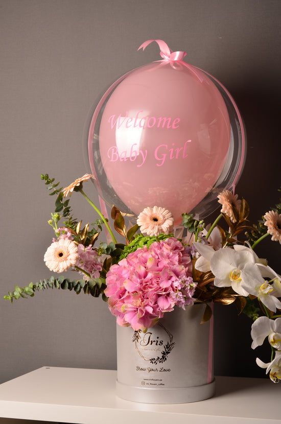 Pink and white flowers box with balloon
