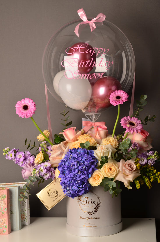 Blue and pink flowers box with balloon
