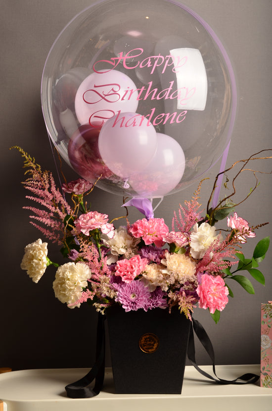 Pink and white flowers box with balloon