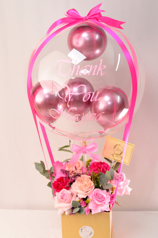 Pink flowers with balloons in box