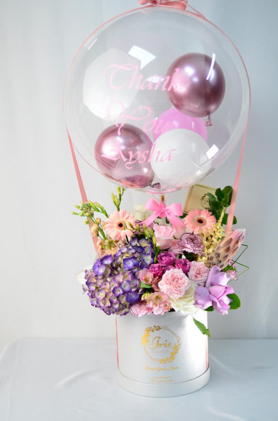 Pink and purple flowers box with balloon