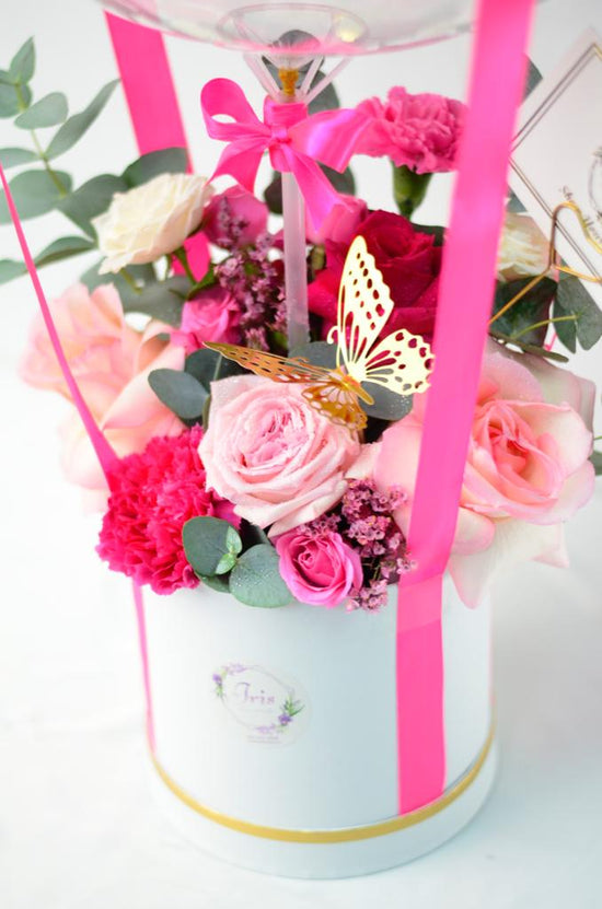 Pink flowers box with balloons