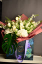 White flowers bouquet in bag