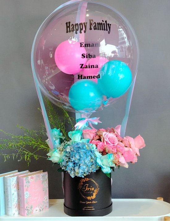 Pink and blue flowers box with balloon