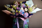 Blue and pink flowers bouquet in bag