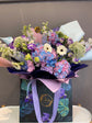 Blue and pink flowers bouquet in bag