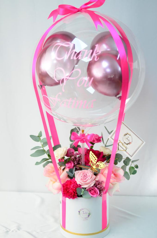 Pink flowers box with balloons