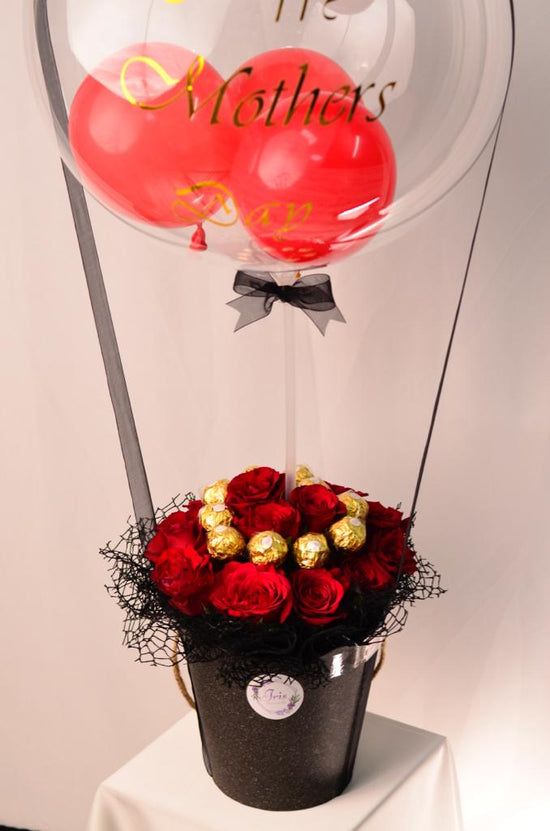 Red rose with ferrero in box