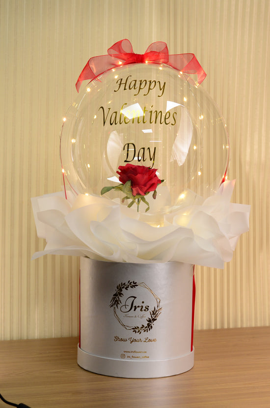 red rose in balloons box