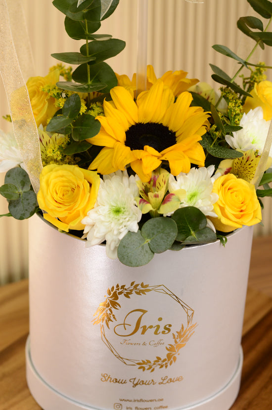 Yellow flowers with balloon in box