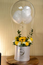 Yellow flowers with balloon in box