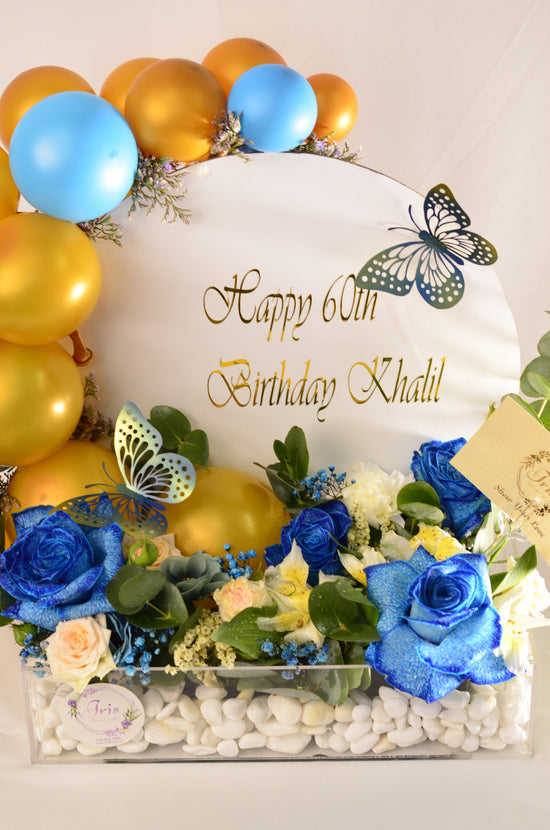 Blue rose and balloons in tray