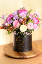 Pink artificial and fresh flowers box