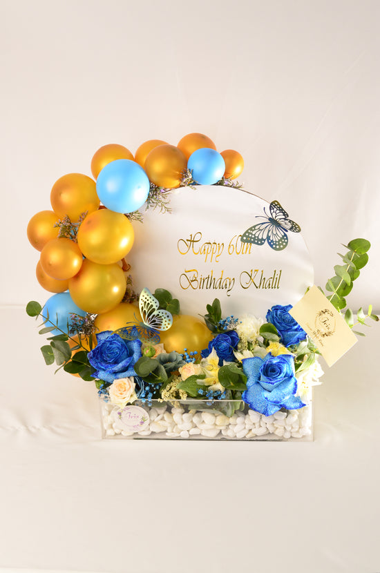 Blue rose and balloons in tray
