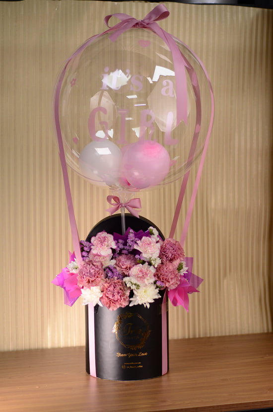 Pink flowers with balloon in box